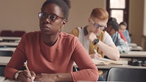African American Female Student Writing Test at University