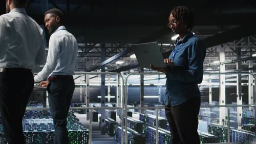 Data Center System Administrators Doing Maintenance Tasks on Laptop