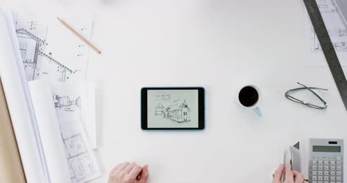 Architect Designs House on Tablet Overhead