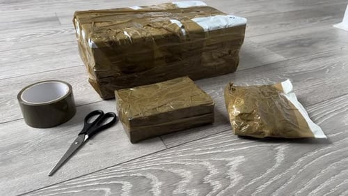 Ebay parcels wrapped Close Up of Cardboard Packages Wrapped with Duct Tape for Shipping and