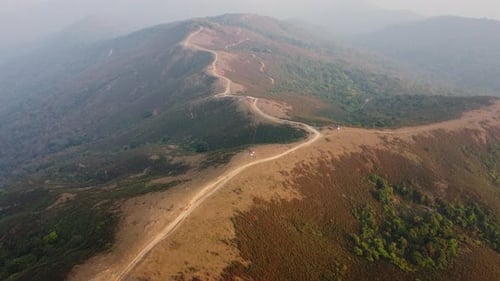 Aerial view of treeless mountain range destroyed by humans.