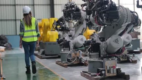 Female Engineer with Digital Tablet Examining Machine Equipment