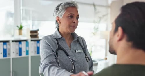 Doctor Comforts Patient During Office Visit