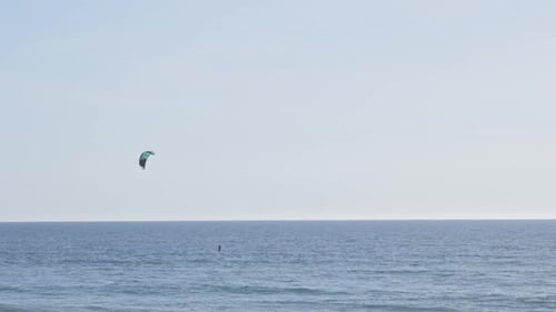 A Person Kitesurfing in the Ocean