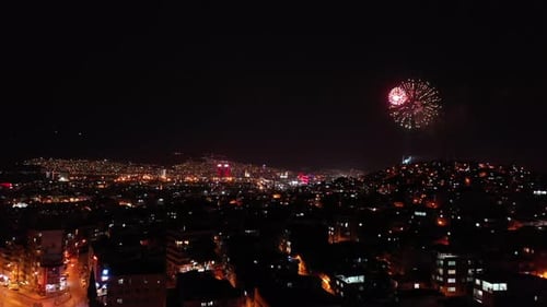 Urban Nightscape with Colorful Fireworks Display
