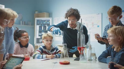 Elementary School Chemistry Classroom: Enthusiastic Teacher Teaches Diverse Group of Children Shows