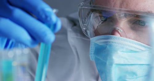 Scientist Holding Test Tube in Medical Lab