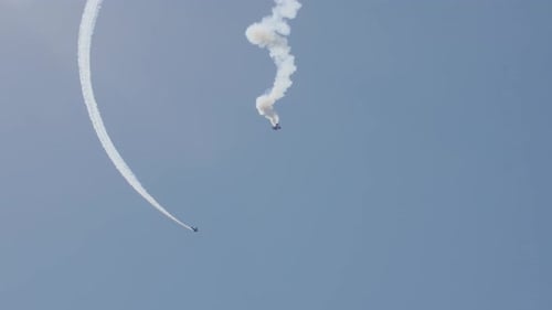 Airplanes Performing Aerobatics Leaving White Smoke Trails