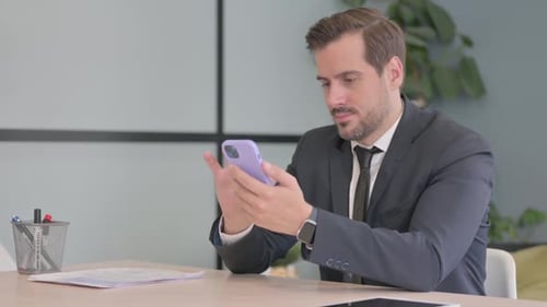 Man Using Smartphone in Corporate Office Setting