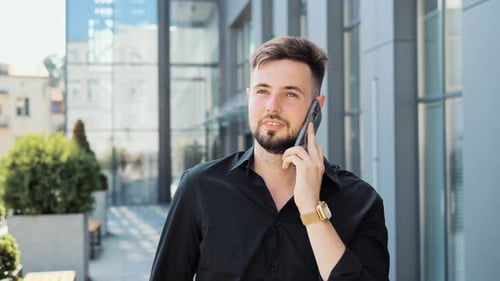 Handsome Young Smart Businessman Freelancer Talking on Smartphone in City