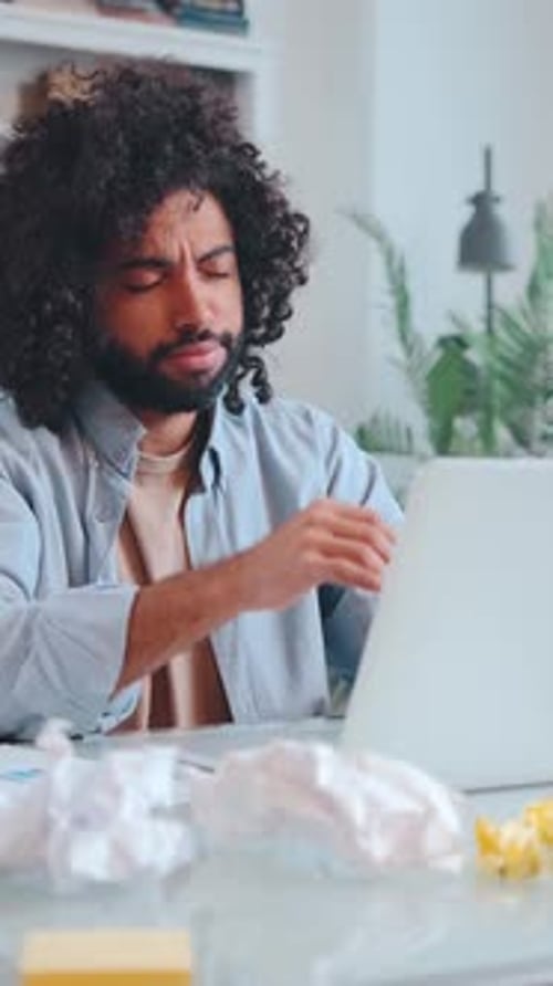 Frustrated Man Working at Home on Laptop