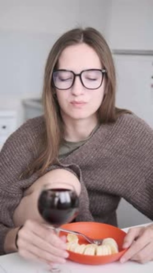 Woman Enjoying Red Wine and Banana at Home Kitchen Casual Meal Cozy Lifestyle