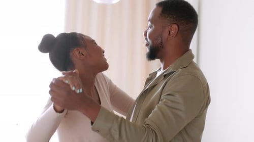 Loving Couple Dancing and Laughing Together at Home