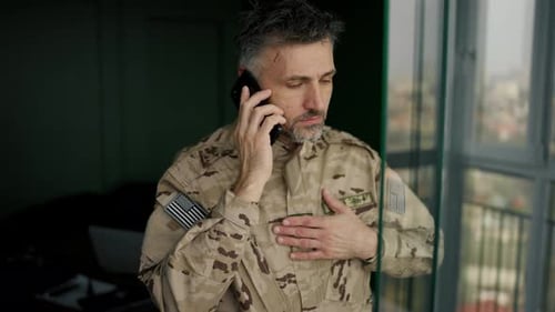 Man In Military Uniform On A Phone Call
