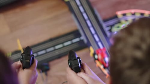 Kids Playing with Toy Slot Car Racing Track