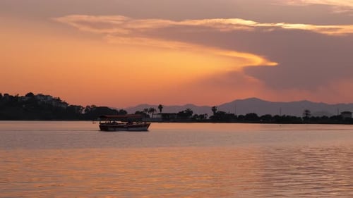 Sailboat Silhouette on Lake During Dusk