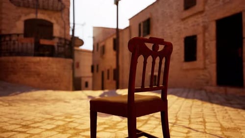 A Wooden Chair Sitting on Top of a Cobblestone Street