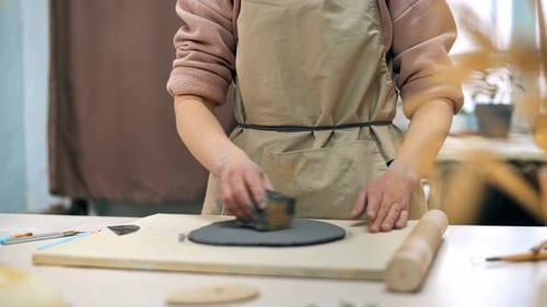 The master of sculpting pottery working in a studio. Smoothing clay
