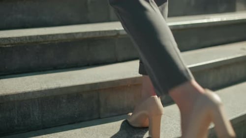 Lower Leg View of Woman Walking in Heels on Pavement Ascending Steps