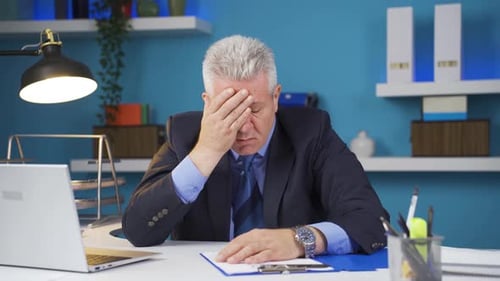 Worried Businessman at Office Desk
