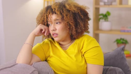 Headache, living room and woman feeling tired and sad in a house lounge
