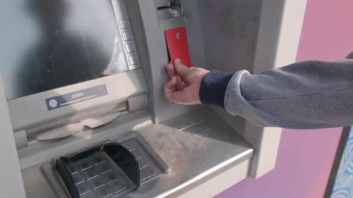 Man Hand Using Contactless Credit Card with NFC at an ATM Entering PIN for Cash Withdrawal Modern