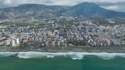 Aerial Video of Growing Coastal City With HighRise Residential Towers Ocean Waves and Rugged