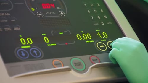 Fitness Testing and Rehabilitation: Adjusting a Treadmill in a Hospital Gym
