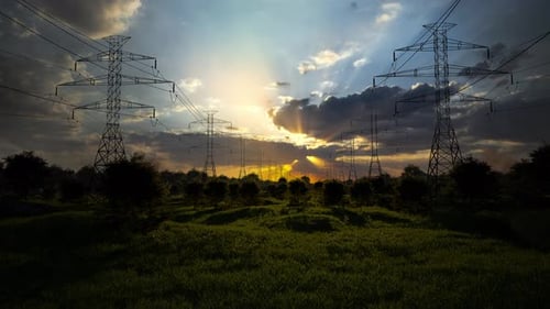 High-Voltage Power Lines At Sunset,High Voltage Electric Transmission Tower