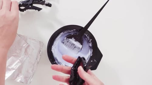 Mixing Hair Dye in Bowl with Brush and Clips