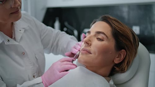 Woman Making Beauty Injection in Cosmetology Clinic Close Up