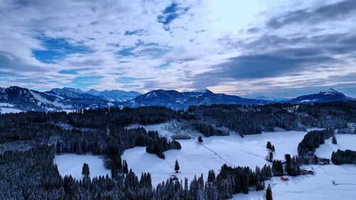 The scene shows a vast area of snow-covered ground surrounded