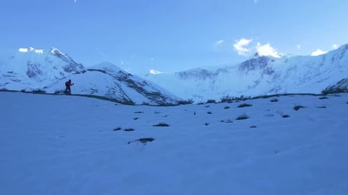 Aerial Cinematic Fly Over View Hiker on Trekking Trail Hike with Poles to Tilicho Base Camp in