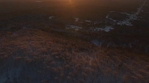 Revealed Golden Sunlight Over Winter Forest Mountains In Southern Quebec, Canada. Aerial Tilt-up
