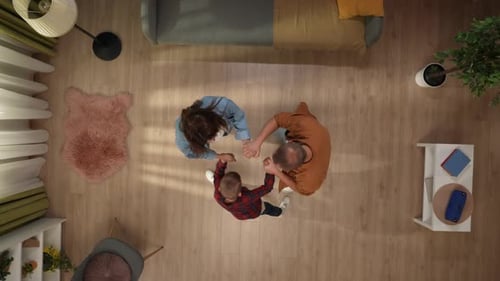 Top View of Living Room Mother Father and Little Son Start Dancing Together Holding Hands and