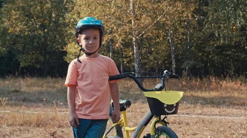 Portrait of a Boy in a Bicycle Helmet on a Walk
