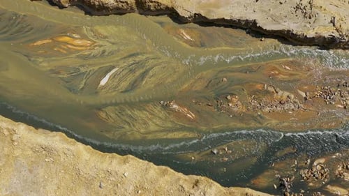 Aerial view of flowing lime and acid mine drainage reaction, water treatment, water remediation