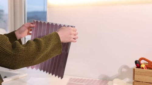 Woman Applying Decorative Tiles to Kitchen Wall