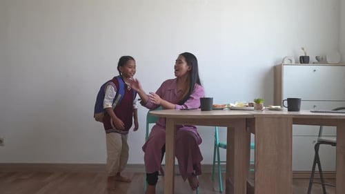 Happy Asian Mother Welcoming Her Two Daughters After Come Back From School And Hug Them