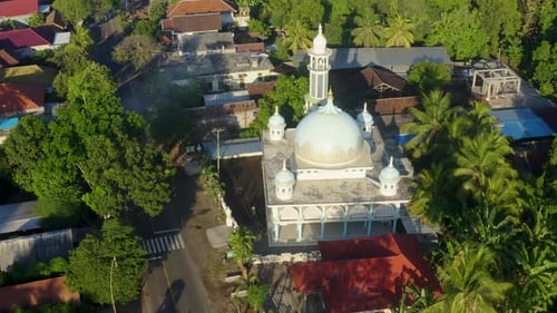 Aerial view of a mosque with a blue dome and minaret, Indonesia.