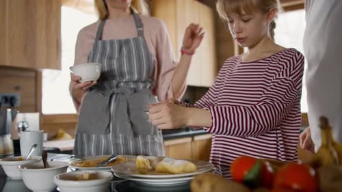 Teen Girl sprinkles powdered sugar on breakfast