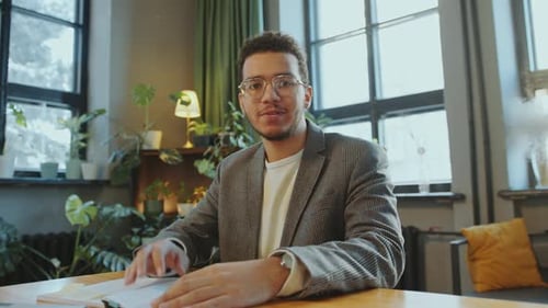 Young Man Speaking to Camera in Indoor Setting