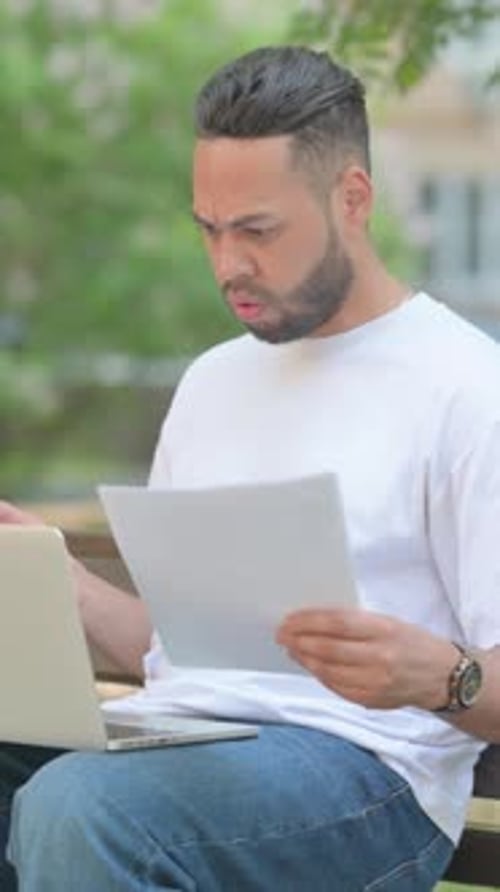 Man Working Outdoors is Upset by Bad News