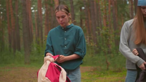 Young Hikers Walking Through Serene Forest