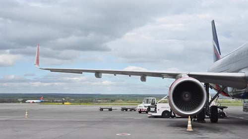 Huge Airplane Jet Engine Close Up View Moving Forward Heat Haze Distant Airplane Lining Up Behind