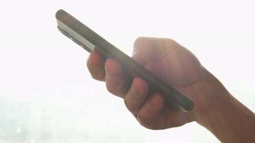 Man Hand Holding Cell Phone Touch Screen Typing Scroll Page Using App Smartphone Mobile Phone Device