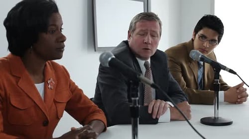 Panel Discussing Corporate Issues in a Meeting Room