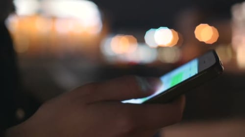 Girl Using Smart Phone Close Up City Night Lights Background