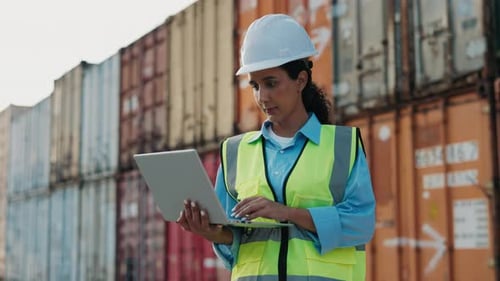 Portrait Of Smiling Female Inspector On Logistics Warehouse Standing Outside And Working Online On