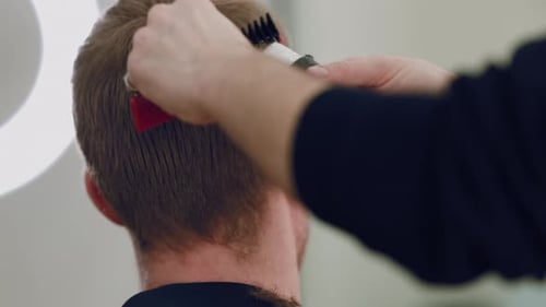 Man Getting a Haircut with Electric Razor Indoors